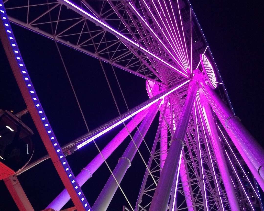ferris wheel lit in pink neon